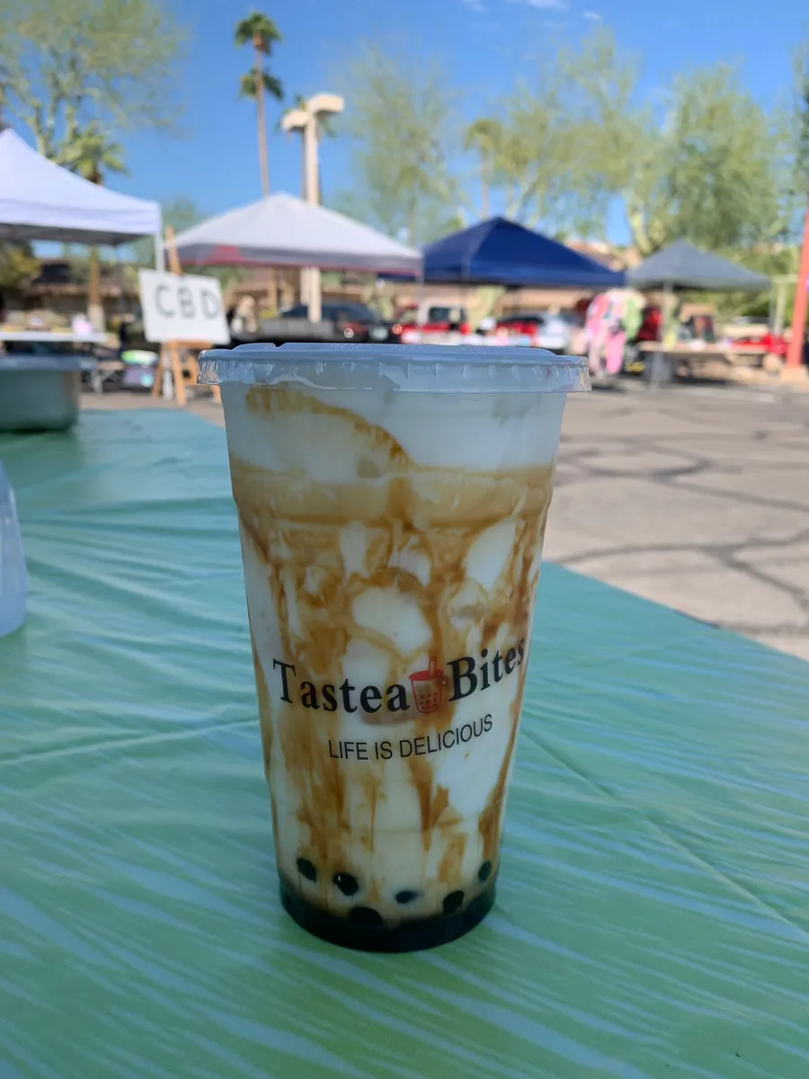Brown sugar milk with syrup streaks down a Tastea Bites cup