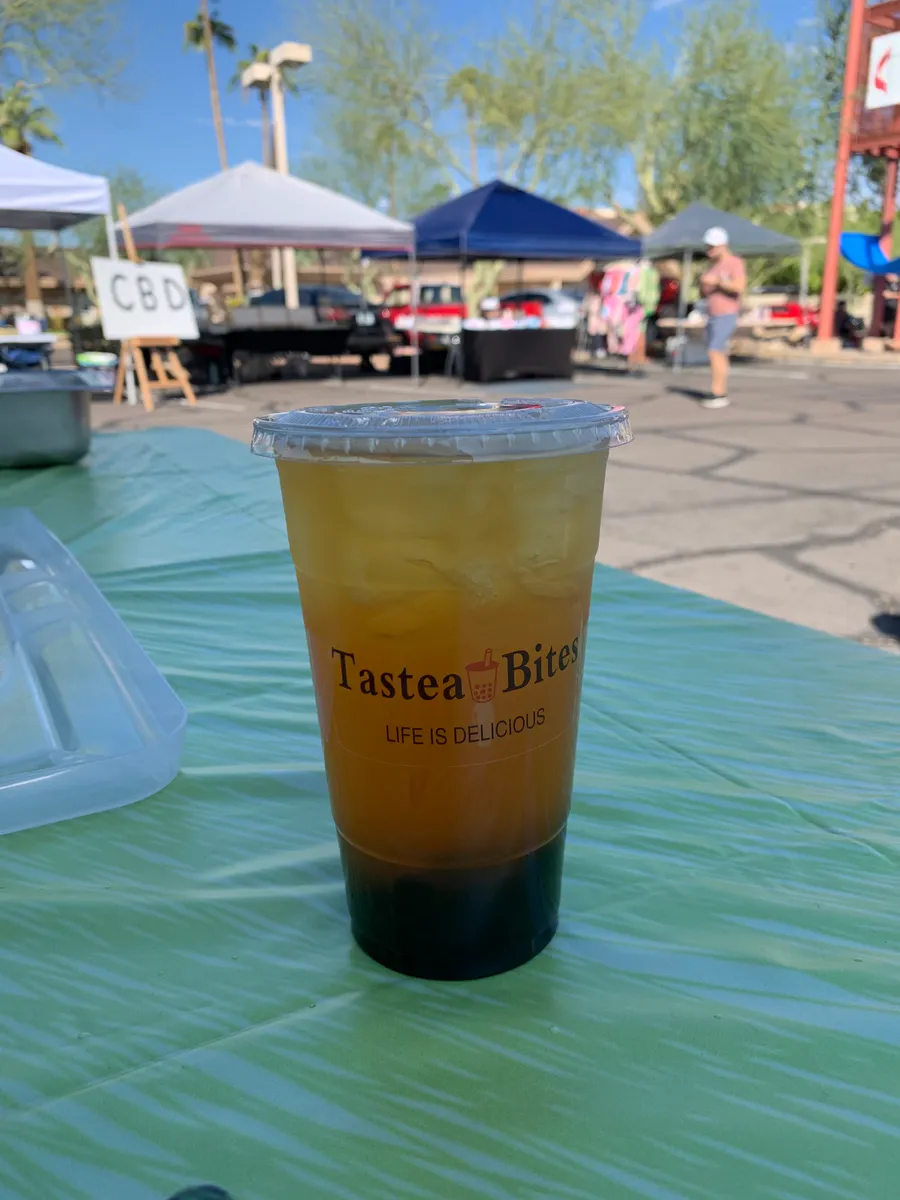 Golden mango green tea over ice with boba, in a Tastea Bites cup