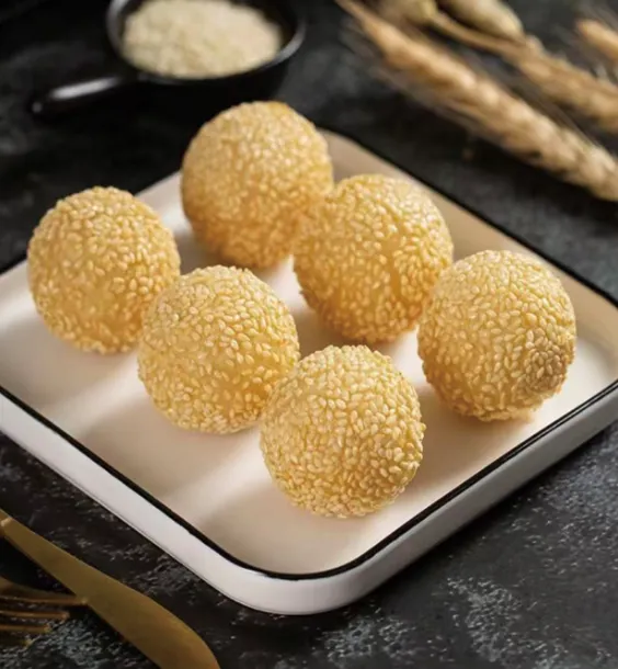 Golden sesame balls on a white tray