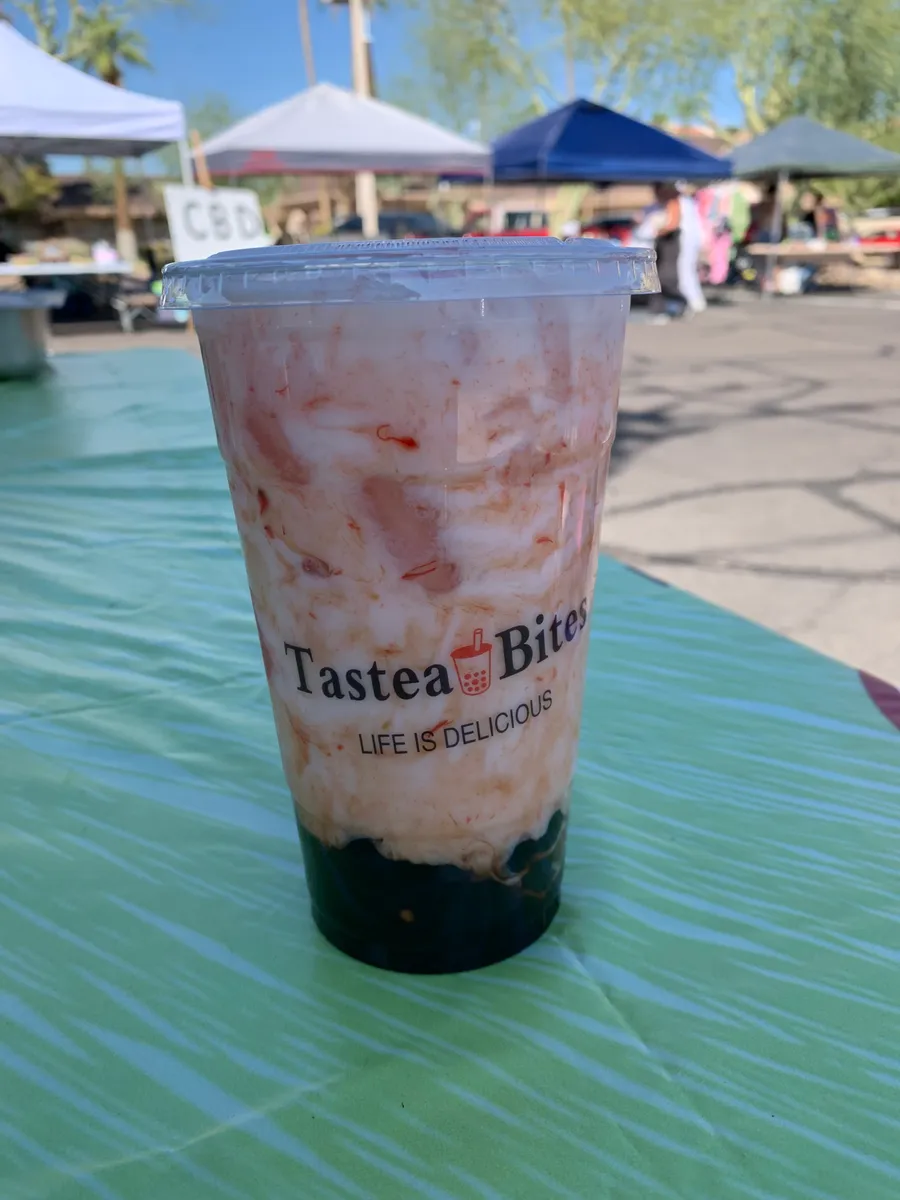Strawberry milk with real strawberry swirls and boba, in a Tastea Bites cup