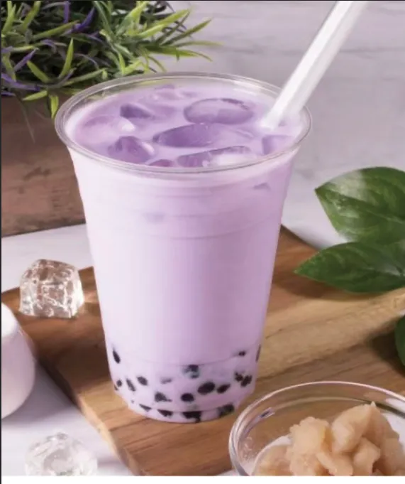 Purple taro milk tea with boba in a clear cup
